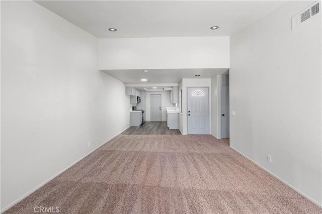 37632 15th St E, Palmdale, CA 93550 - unfurnished living room featuring light colored carpet, washer / clothes dryer, and recessed lighting