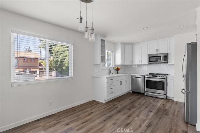 242 N 10th St Unit 242, Grover Beach, CA 93433 - kitchen with appliances with stainless steel finishes, dark wood-type flooring, healthy amount of natural light, backsplash, and recessed lighting