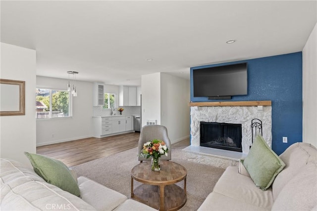 242 N 10th St Unit 242, Grover Beach, CA 93433 - living area featuring a stone fireplace, light wood-style flooring, and recessed lighting