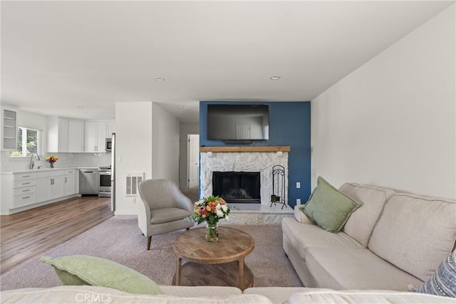 242 N 10th St Unit 242, Grover Beach, CA 93433 - living room with light wood-style floors, a fireplace, and recessed lighting