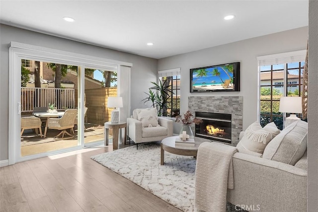 12152 Napoli Dr, Cerritos, CA 90703 - living room with wood finished floors, a tiled fireplace, healthy amount of natural light, and recessed lighting
