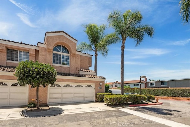 12152 Napoli Dr, Cerritos, CA 90703 - mediterranean / spanish-style home with a tiled roof, stucco siding, driveway, and a garage