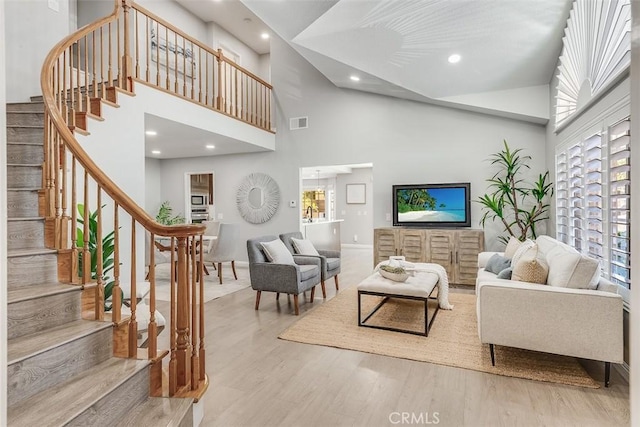 12152 Napoli Dr, Cerritos, CA 90703 - living area featuring a high ceiling, wood finished floors, stairway, and recessed lighting