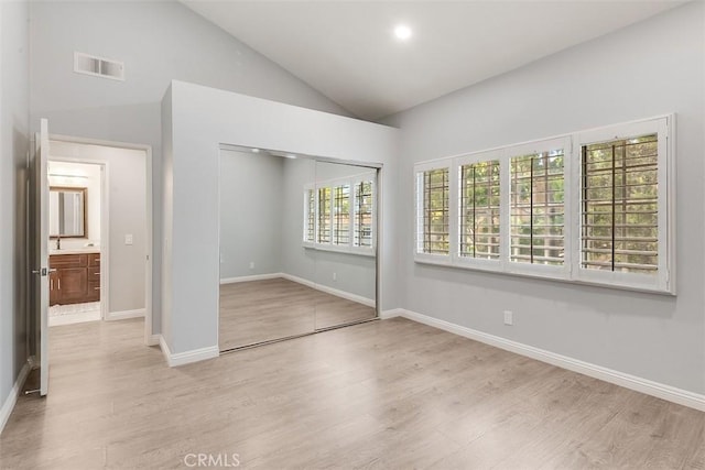 12152 Napoli Dr, Cerritos, CA 90703 - unfurnished bedroom featuring wood finished floors, a closet, and high vaulted ceiling