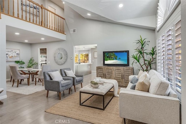12152 Napoli Dr, Cerritos, CA 90703 - living room with wood finished floors, high vaulted ceiling, and recessed lighting