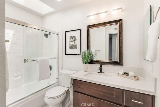 12152 Napoli Dr, Cerritos, CA 90703 - bathroom featuring a skylight, vanity, and enclosed tub / shower combo