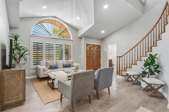 12152 Napoli Dr, Cerritos, CA 90703 - living area featuring light wood-type flooring, stairs, recessed lighting, and high vaulted ceiling