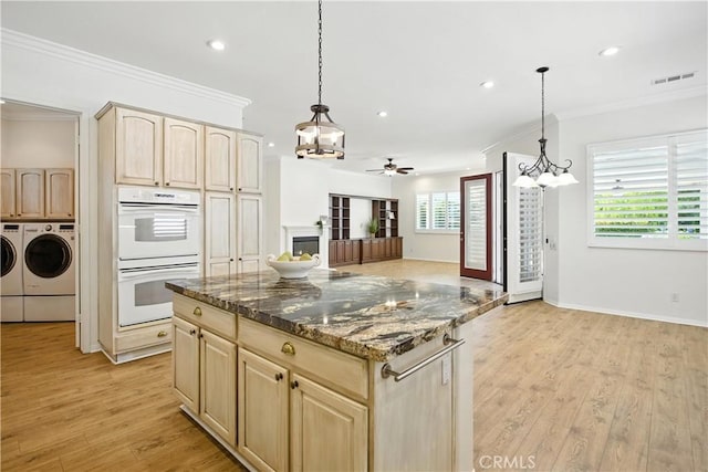 1740 Las Colinas Rd, Beaumont, CA 92223 - kitchen featuring white double oven, light brown cabinetry, independent washer and dryer, a chandelier, and ornamental molding