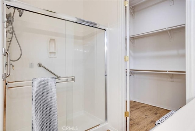 1740 Las Colinas Rd, Beaumont, CA 92223 - bathroom featuring a stall shower, wood finished floors, and a spacious closet