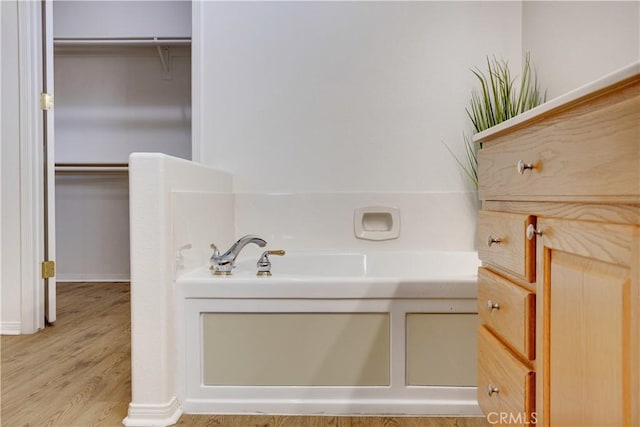 1740 Las Colinas Rd, Beaumont, CA 92223 - full bathroom featuring a bath, wood finished floors, and a spacious closet