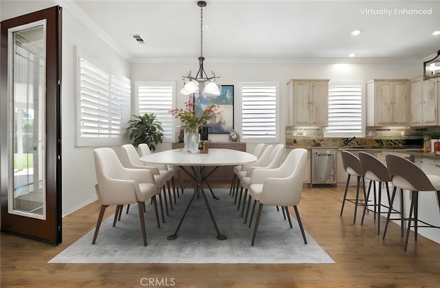 1740 Las Colinas Rd, Beaumont, CA 92223 - dining space featuring crown molding, light wood-type flooring, recessed lighting, and a chandelier