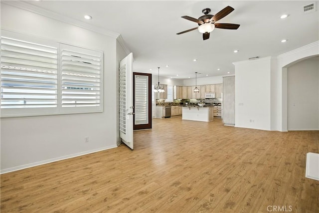 1740 Las Colinas Rd, Beaumont, CA 92223 - unfurnished living room featuring crown molding, ceiling fan, arched walkways, recessed lighting, and light wood finished floors