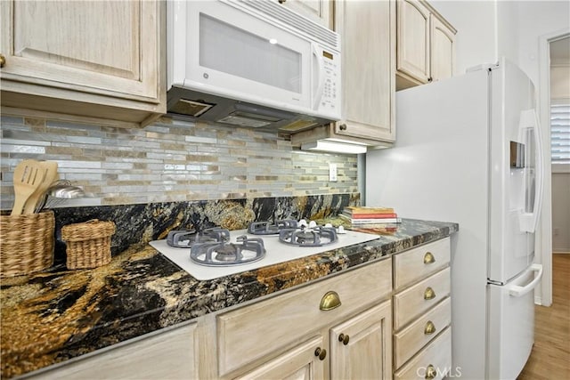 1740 Las Colinas Rd, Beaumont, CA 92223 - kitchen featuring white appliances, backsplash, light wood-style flooring, dark stone counters, and light brown cabinets