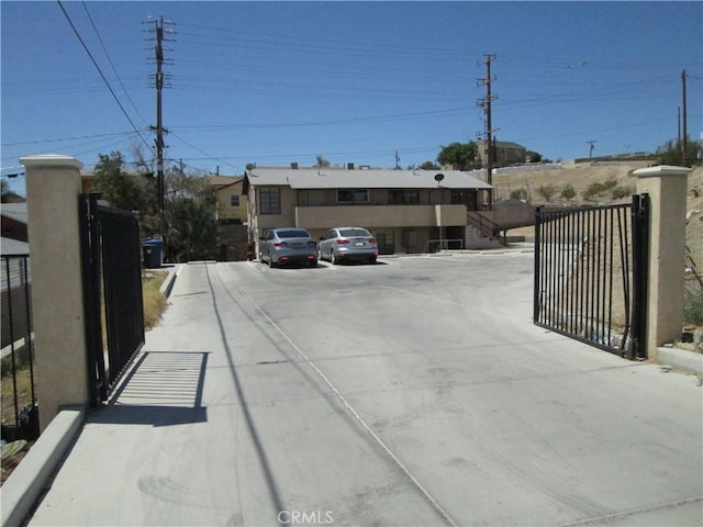 201 W Williams St, Barstow, CA 92311 - view of concrete driveway featuring a gated entry