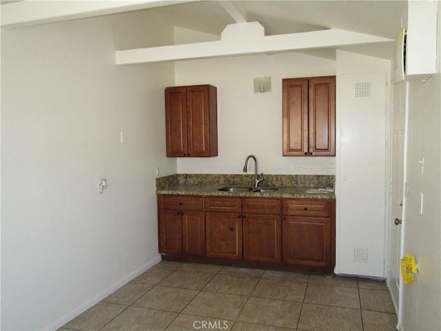 201 W Williams St, Barstow, CA 92311 - kitchen featuring vaulted ceiling and light tile patterned floors