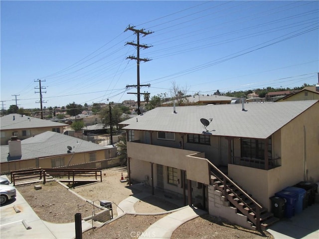 201 W Williams St, Barstow, CA 92311 - rear view of property with stairway and stucco siding