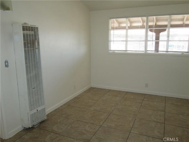 201 W Williams St, Barstow, CA 92311 - tiled spare room with a heating unit and baseboards