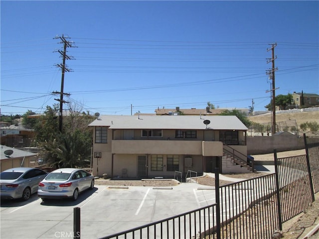 201 W Williams St, Barstow, CA 92311 - view of property featuring stairway and uncovered parking