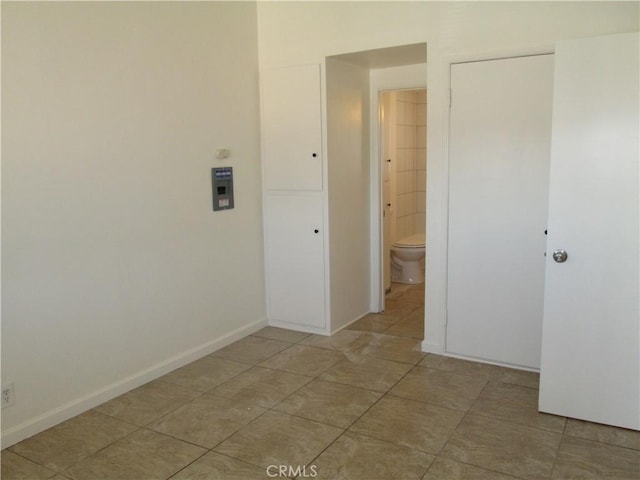 201 W Williams St, Barstow, CA 92311 - laundry room with light tile patterned floors and baseboards