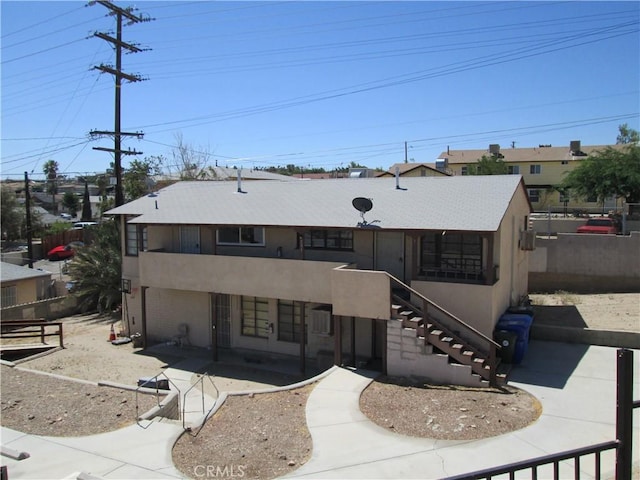 201 W Williams St, Barstow, CA 92311 - view of front of house with a patio area, stucco siding, and stairs