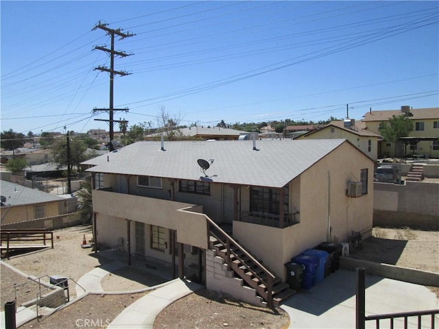 201 W Williams St, Barstow, CA 92311 - rear view of property with stairs, a patio area, and stucco siding