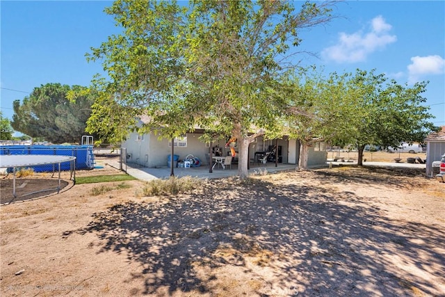 10000 8th Ave, Hesperia, CA 92345 - view of side of property with a patio and stucco siding