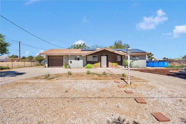 10000 8th Ave, Hesperia, CA 92345 - ranch-style house featuring driveway, a garage, and roof mounted solar panels