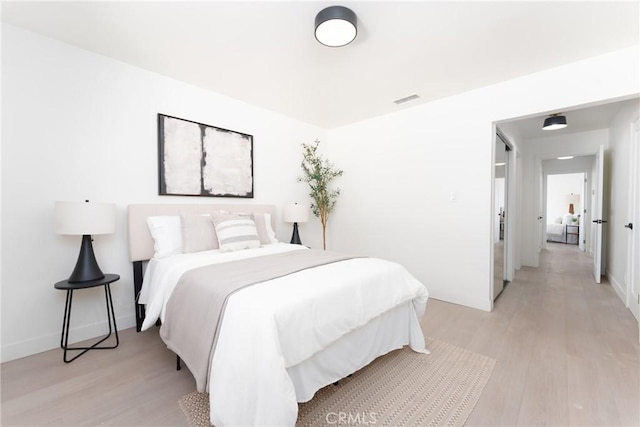 13203 Lakewood Blvd, Downey, CA 90242 - bedroom with light wood finished floors and baseboards