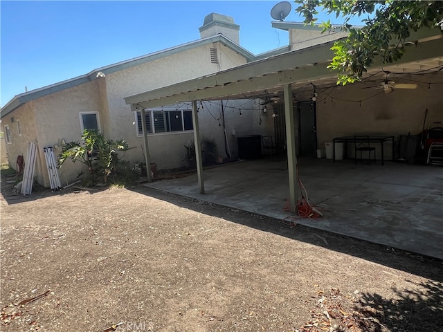 946 W Woodcrest, Bloomington, CA 92316 - back of property featuring an attached carport, ceiling fan, stucco siding, and a patio
