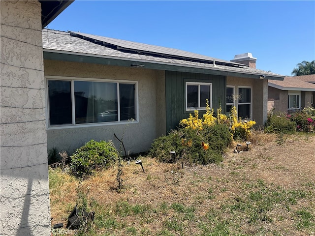 946 W Woodcrest, Bloomington, CA 92316 - view of side of property with solar panels and a chimney