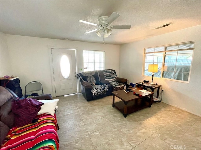 1325 Norton Ave, Dos Palos, CA 93620 - living area featuring a textured ceiling and a ceiling fan