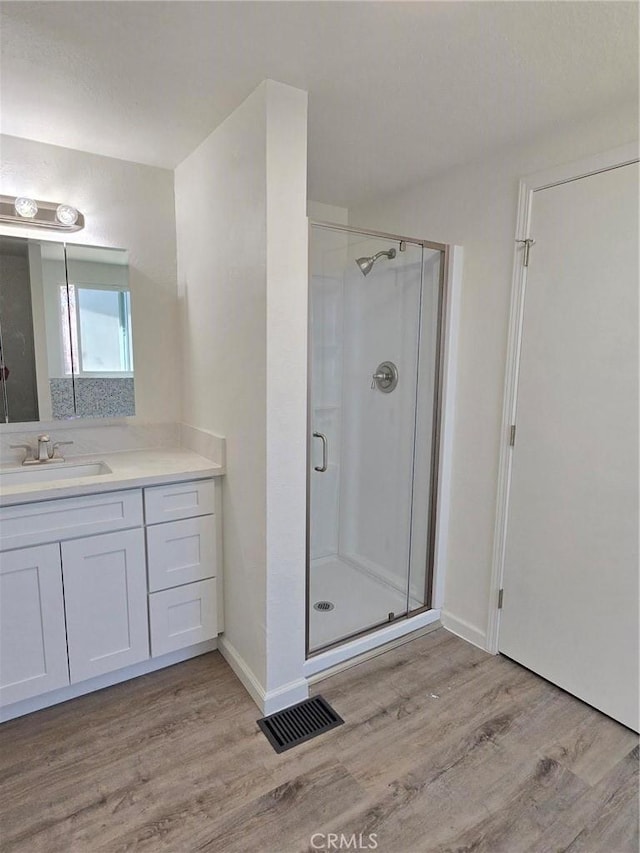 18812 Arbor Ct, Adelanto, CA 92301 - bathroom featuring wood finished floors, vanity, and a shower stall