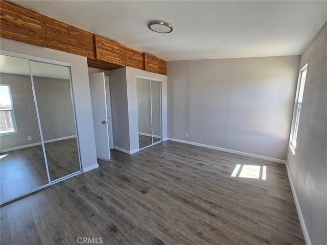 18812 Arbor Ct, Adelanto, CA 92301 - unfurnished bedroom with multiple windows, dark wood-type flooring, and a closet