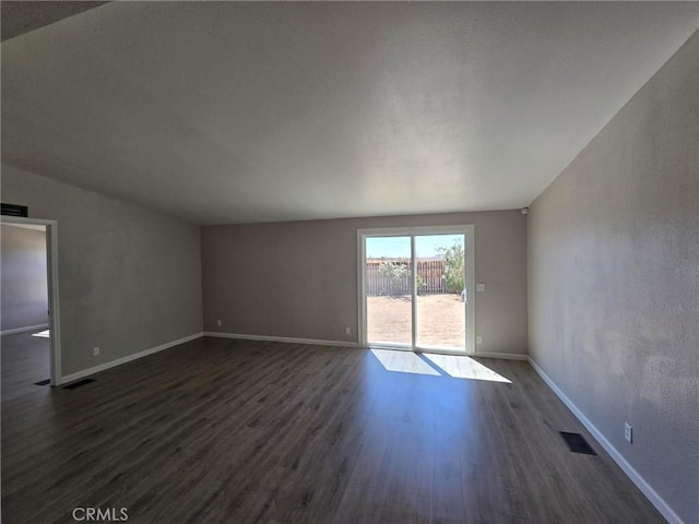 18812 Arbor Ct, Adelanto, CA 92301 - unfurnished room with dark wood-style flooring and lofted ceiling