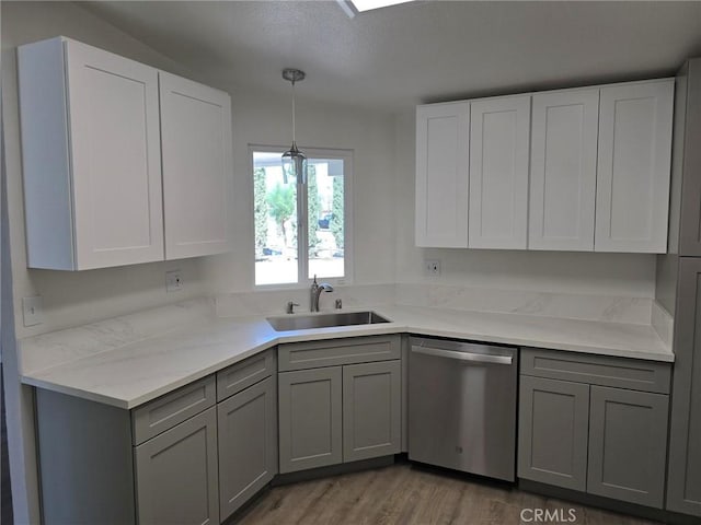 18812 Arbor Ct, Adelanto, CA 92301 - kitchen featuring stainless steel dishwasher, gray cabinetry, wood finished floors, light countertops, and hanging light fixtures