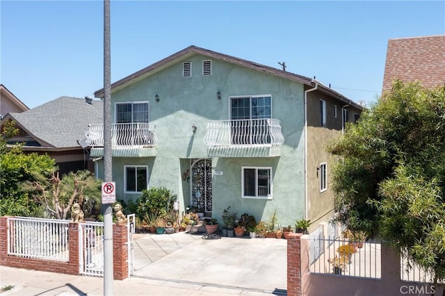 795 E 42nd Pl, Los Angeles, CA 90011 - view of front of property featuring stucco siding, a balcony, and a patio
