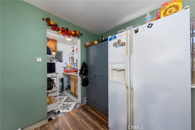 795 E 42nd Pl, Los Angeles, CA 90011 - kitchen with white fridge with ice dispenser and wood finished floors