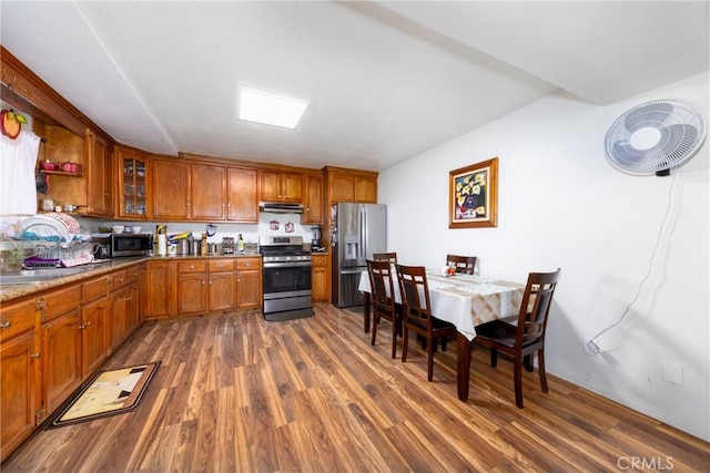 795 E 42nd Pl, Los Angeles, CA 90011 - kitchen featuring stainless steel appliances, brown cabinets, dark wood-type flooring, and under cabinet range hood
