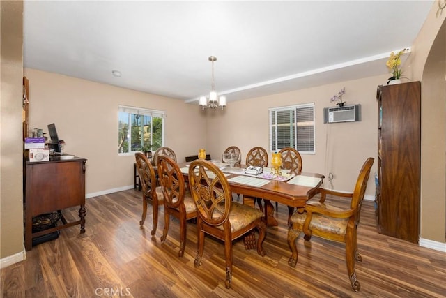 795 E 42nd Pl, Los Angeles, CA 90011 - dining room with an AC wall unit, wood finished floors, and a chandelier