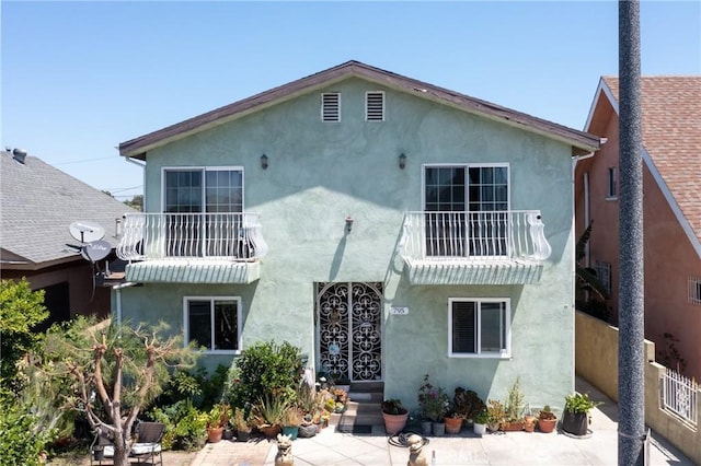 795 E 42nd Pl, Los Angeles, CA 90011 - rear view of property with a balcony, stucco siding, and a patio