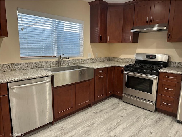 350 E 223rd St, Carson, CA 90745 - kitchen with appliances with stainless steel finishes, under cabinet range hood, light wood-type flooring, and light countertops