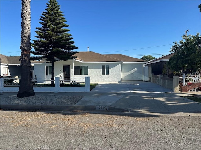 350 E 223rd St, Carson, CA 90745 - view of front of home featuring stucco siding, a garage, concrete driveway, and roof with shingles