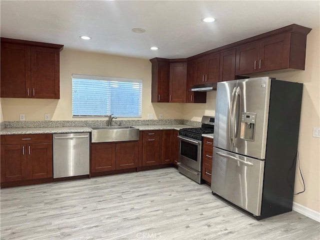 350 E 223rd St, Carson, CA 90745 - kitchen featuring appliances with stainless steel finishes, under cabinet range hood, light wood-type flooring, recessed lighting, and light stone counters