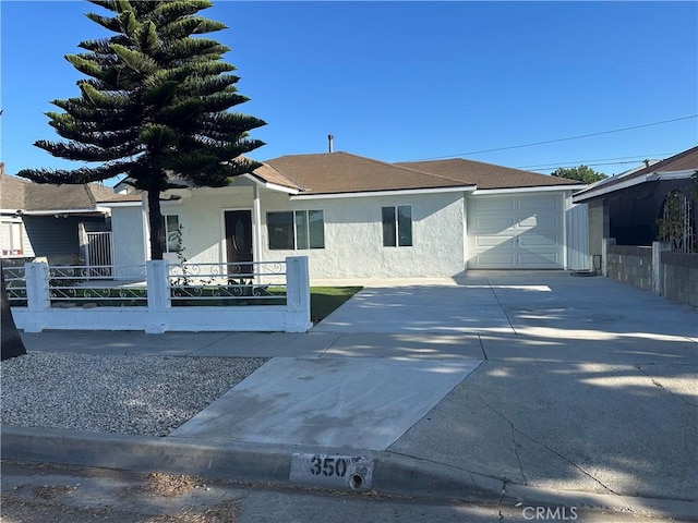 350 E 223rd St, Carson, CA 90745 - view of front of house with stucco siding, driveway, and a garage