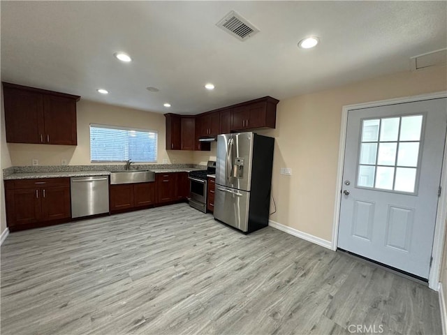 350 E 223rd St, Carson, CA 90745 - kitchen featuring appliances with stainless steel finishes, light wood-style floors, under cabinet range hood, recessed lighting, and light stone counters