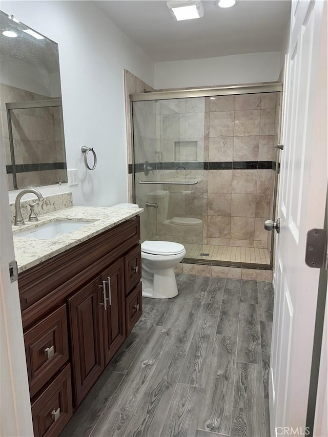 350 E 223rd St, Carson, CA 90745 - bathroom featuring vanity, a stall shower, and wood finished floors