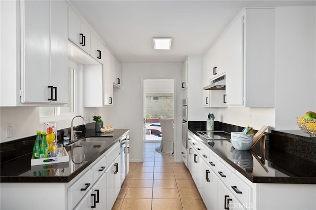 6152 Anthony Ave, Garden Grove, CA 92845 - kitchen featuring under cabinet range hood, black electric cooktop, plenty of natural light, and light tile patterned flooring