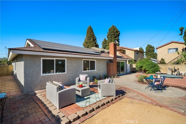 6152 Anthony Ave, Garden Grove, CA 92845 - rear view of house featuring an outdoor hangout area, stucco siding, a patio, and roof mounted solar panels