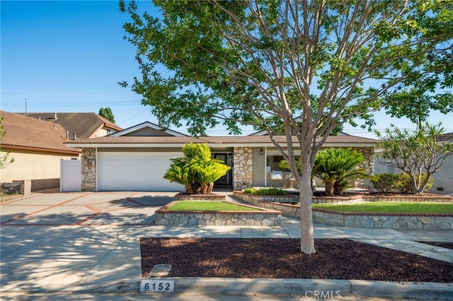 6152 Anthony Ave, Garden Grove, CA 92845 - view of front facade featuring stone siding, driveway, and a garage