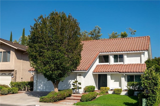 12 Ninos, Irvine, CA 92620 - view of front of home featuring a garage, driveway, a tile roof, and stucco siding